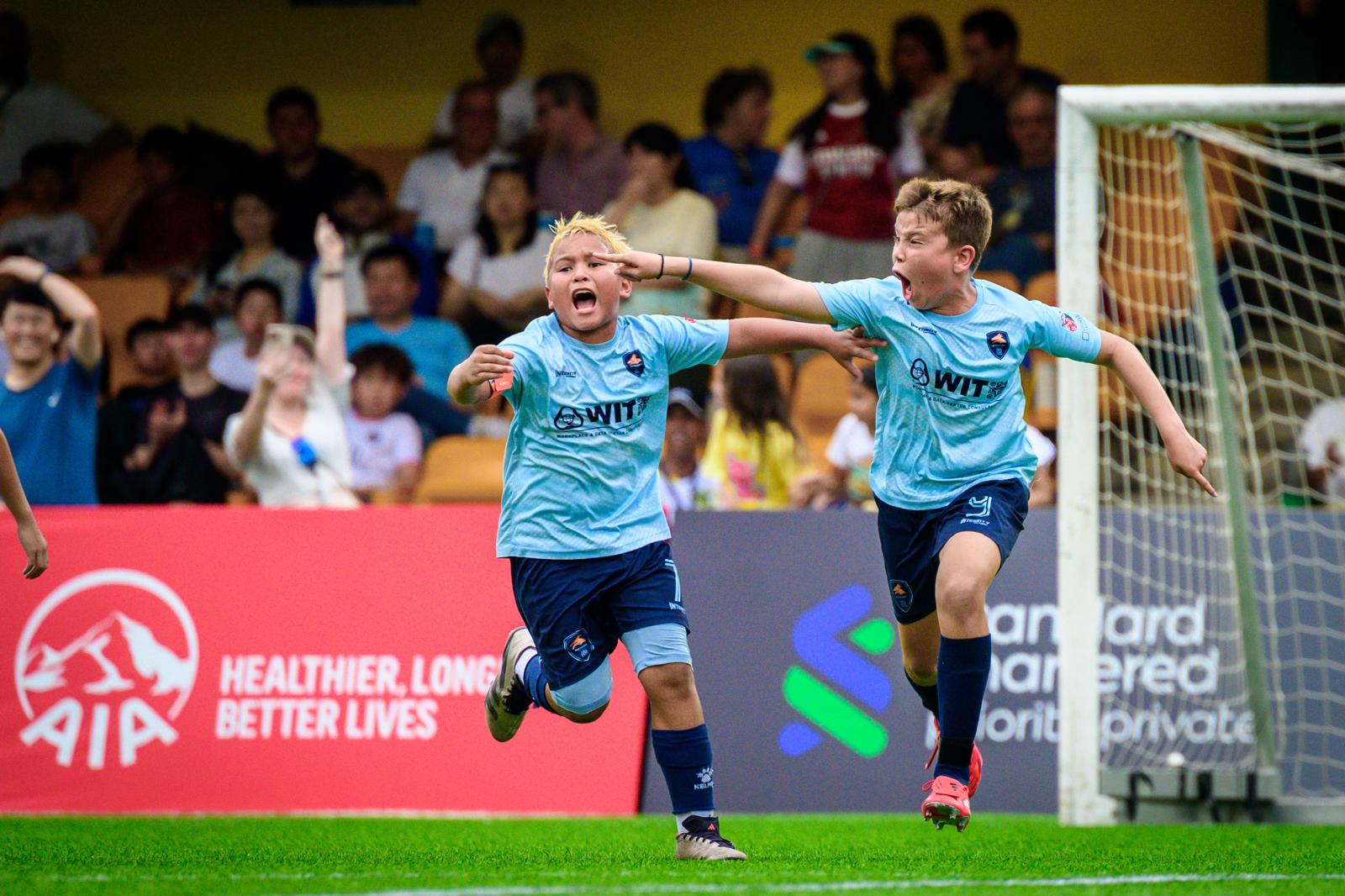 Dragons players celebrating a goal at a tournament