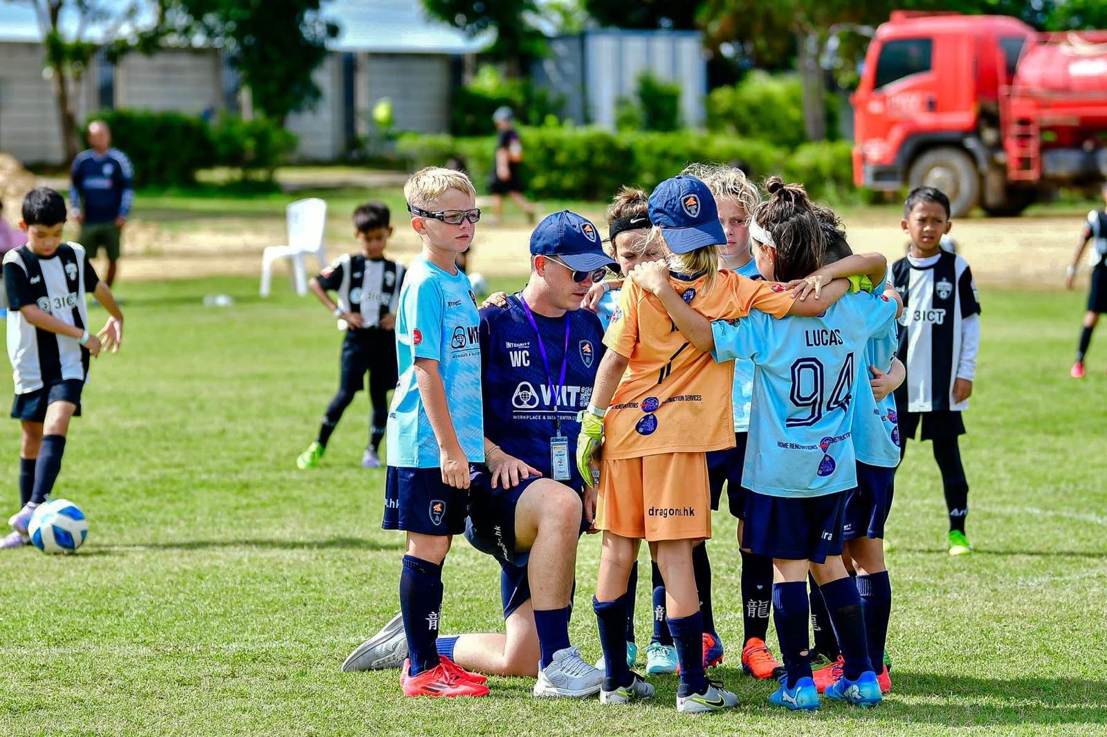 A group of young Dragons gathered together on the pitch