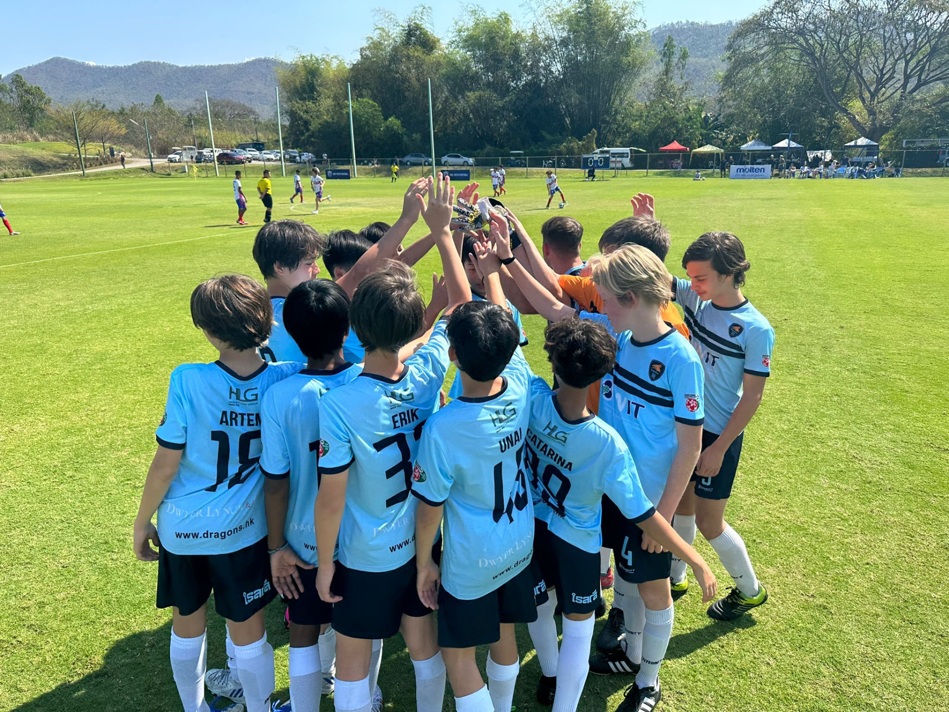 Young footballers celebrating at an international tournament in Thailand