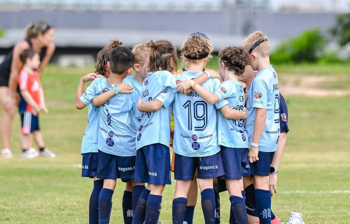 Dragons players embracing in celebration after a match