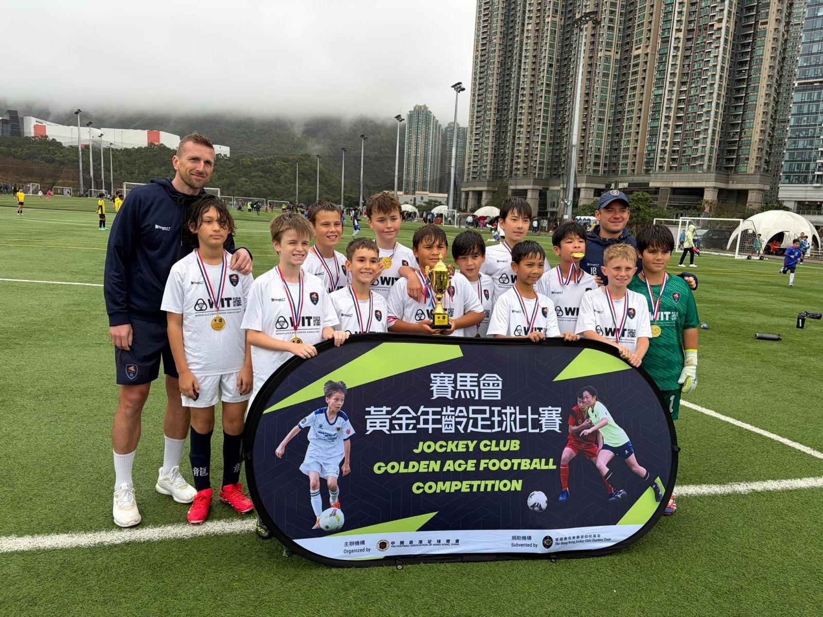 A Dragons team with their coaches at the Jockey Club Golden Age competition