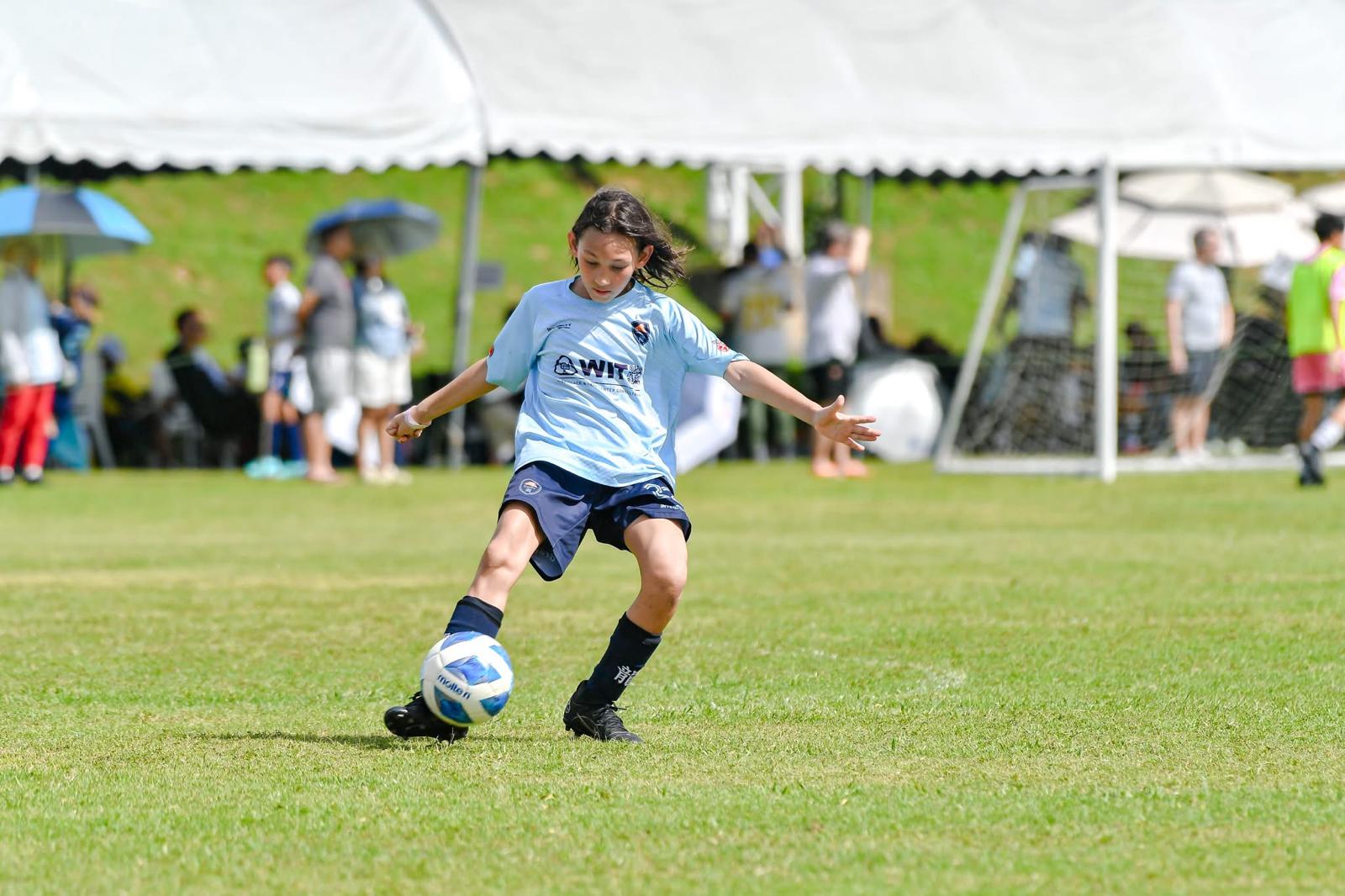 A Dragons player driving forward with the ball