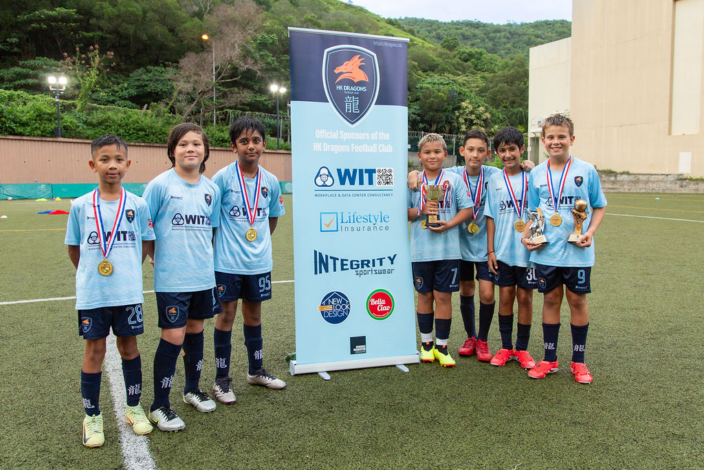 Dragons team lined up with medals and player of the day awards