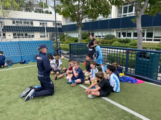 Coach leading a group chat during a Dragons training session